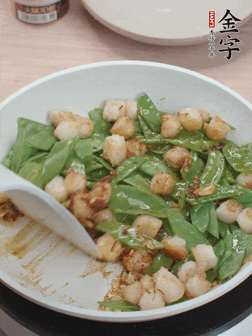 下甜豆莢、鮮貝輕輕翻炒均勻。